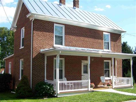 red brick house with white metal roof|metal roofs on brick houses.